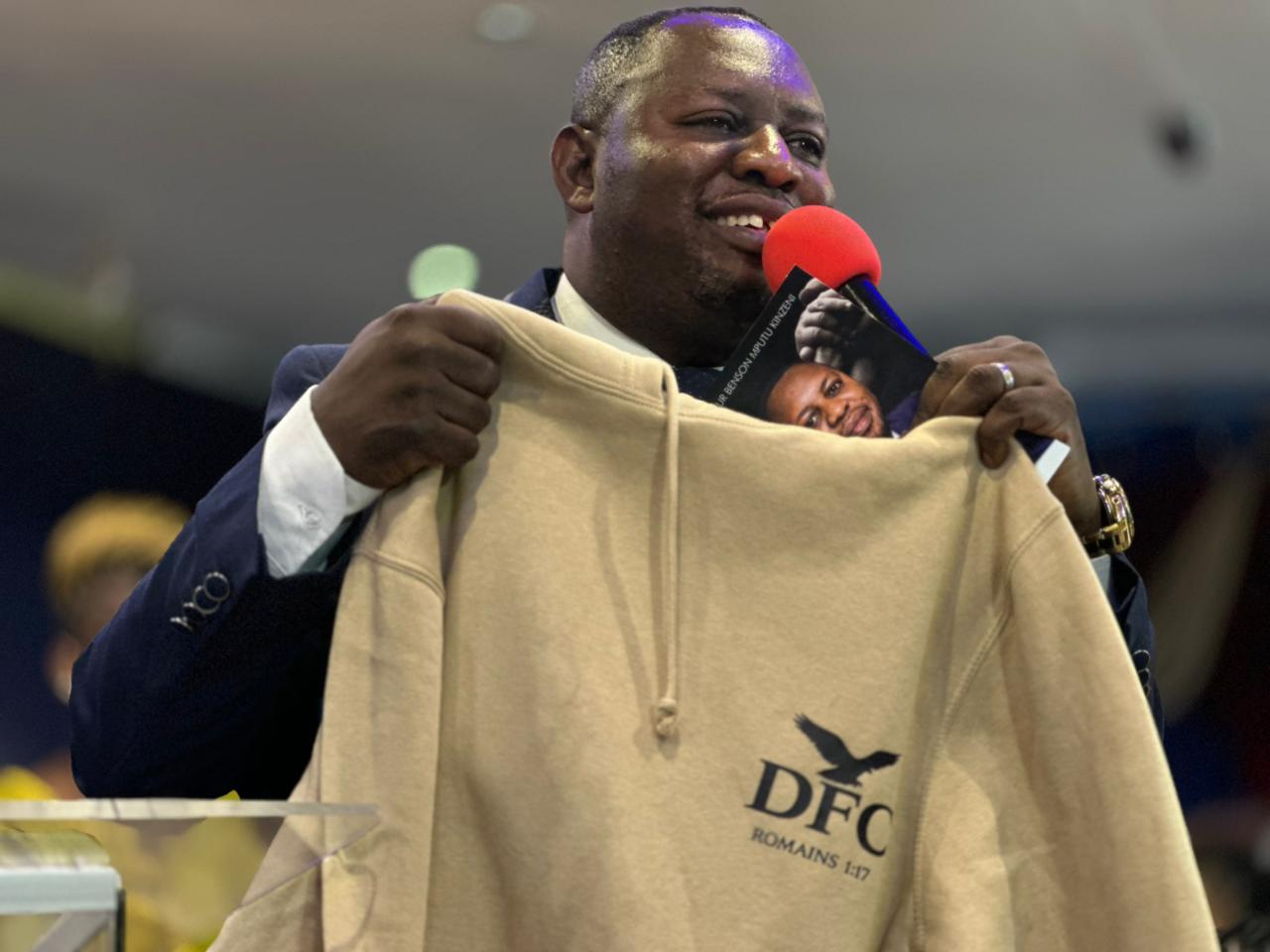DFC Branded Beige Hoodie presented by Pasteur Benson Mputu Kinzeni